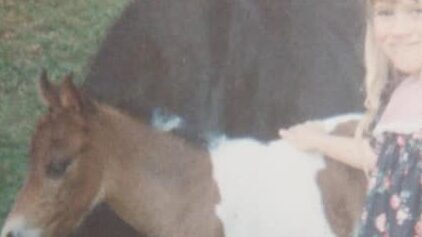 Katie as a child with her first pony.