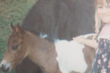 Katie as a child with her first pony.